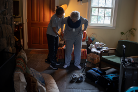 Aide helps woman at her home
