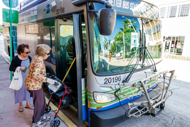 Two women get on a metro bus