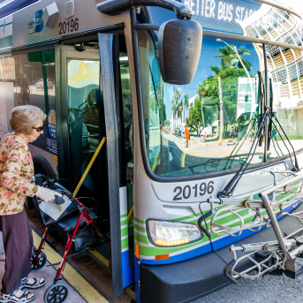 Two women get on a metro bus