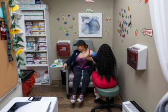 Woman gets blood drawn in clinic