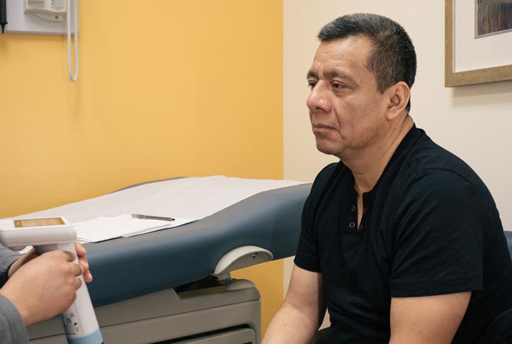 Man sits for an exam by doctor