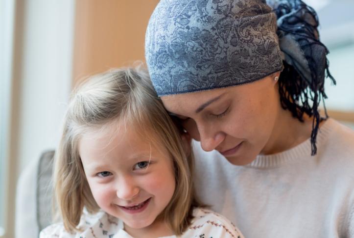 Cancer survivor holds her daughter