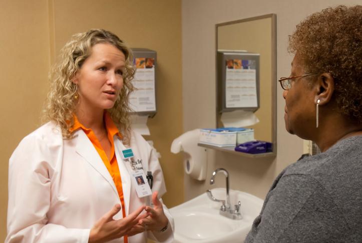 Doctor and patient go over paperwork for insurance marketplace