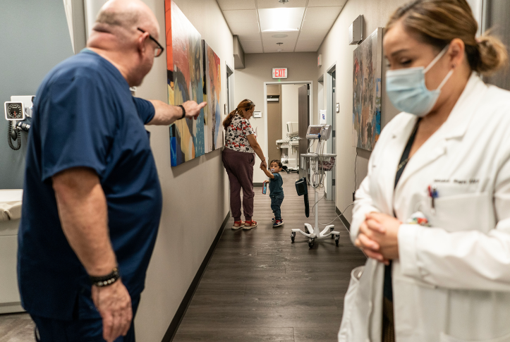 Doctor waves to patients down the hall