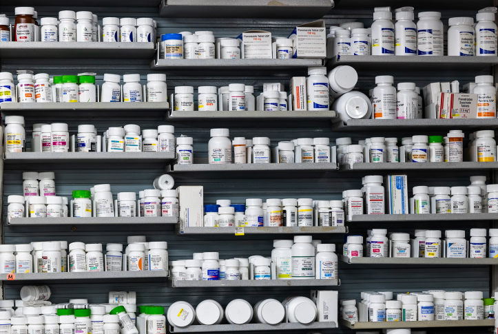 Wall of prescription drug bottles on shelves