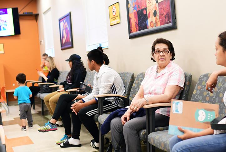 People in waiting room waiting for health care