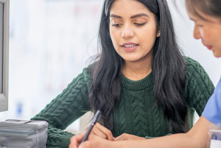 female with health insurance visiting doctor