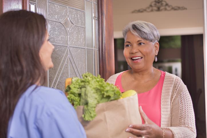 Woman receiving groceries and nutritional support
