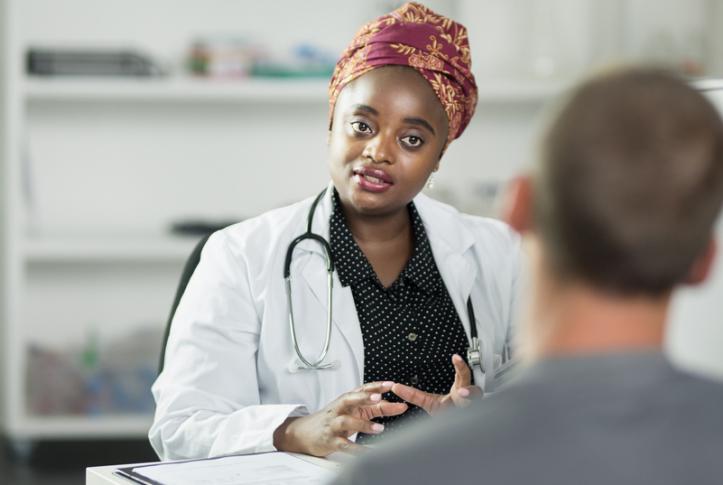 primary care physician listens to low-income patient