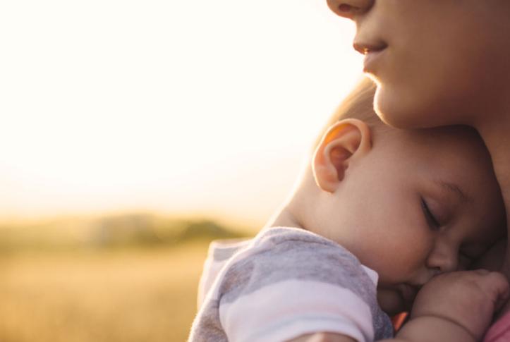 rural woman with new infant in field