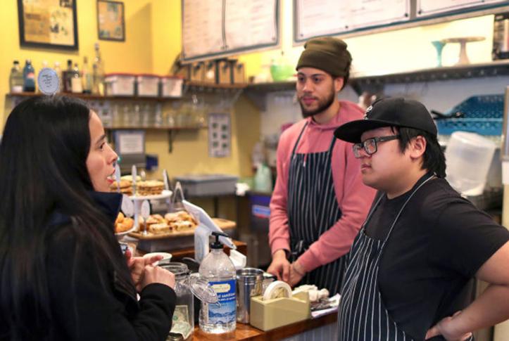 small business employees talk to customer