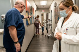 Doctor waves to patients down the hall